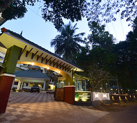 Edhini Ayurveda lit entrance pavilion at dusk